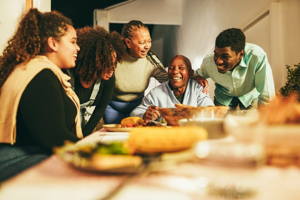 Supporting Immigrants eating dinner together at home terrace outdoor